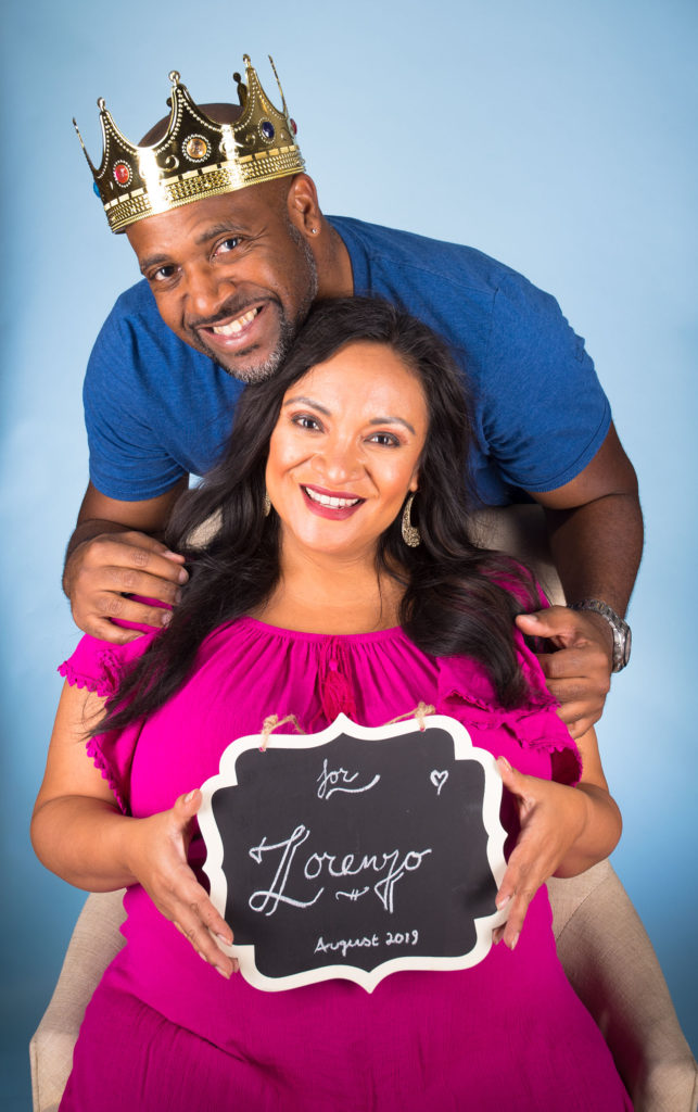Zod and Drea holding a Lorenzo sign